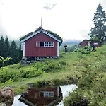 Historic Log House At The Foot Of Middagstind